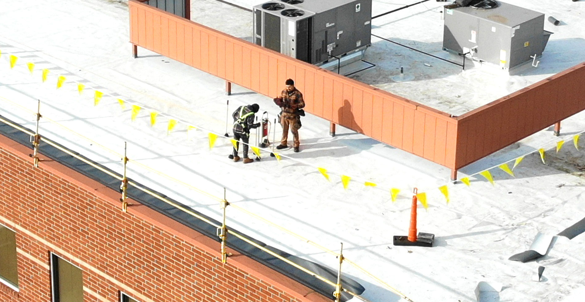 two commercial roofers at work