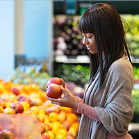 a young woman shopping in a produce aisle 