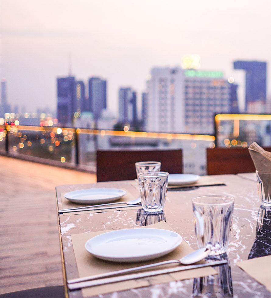 rooftop restaurant at sunset with city view